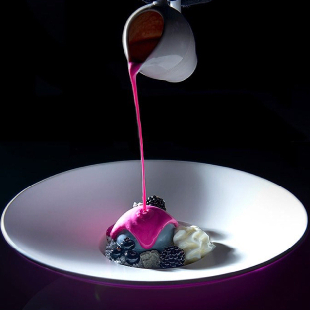 Pink sauce poured over a plated dessert