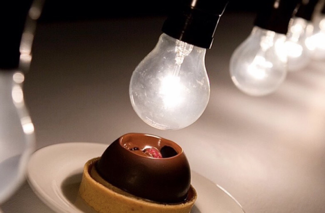 Dessert beneath glowing hanging bulbs