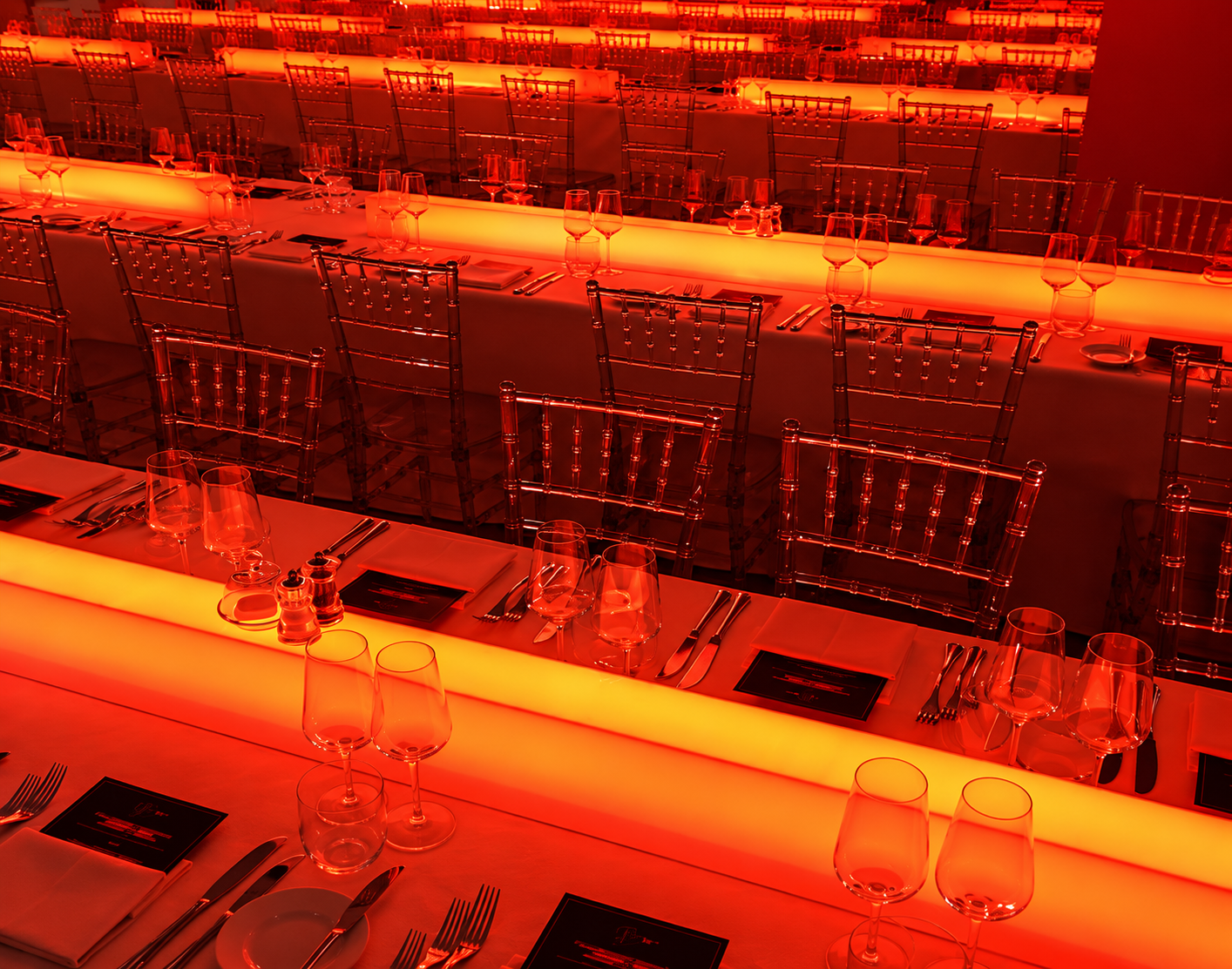 Red illuminated large-scale dinner setting