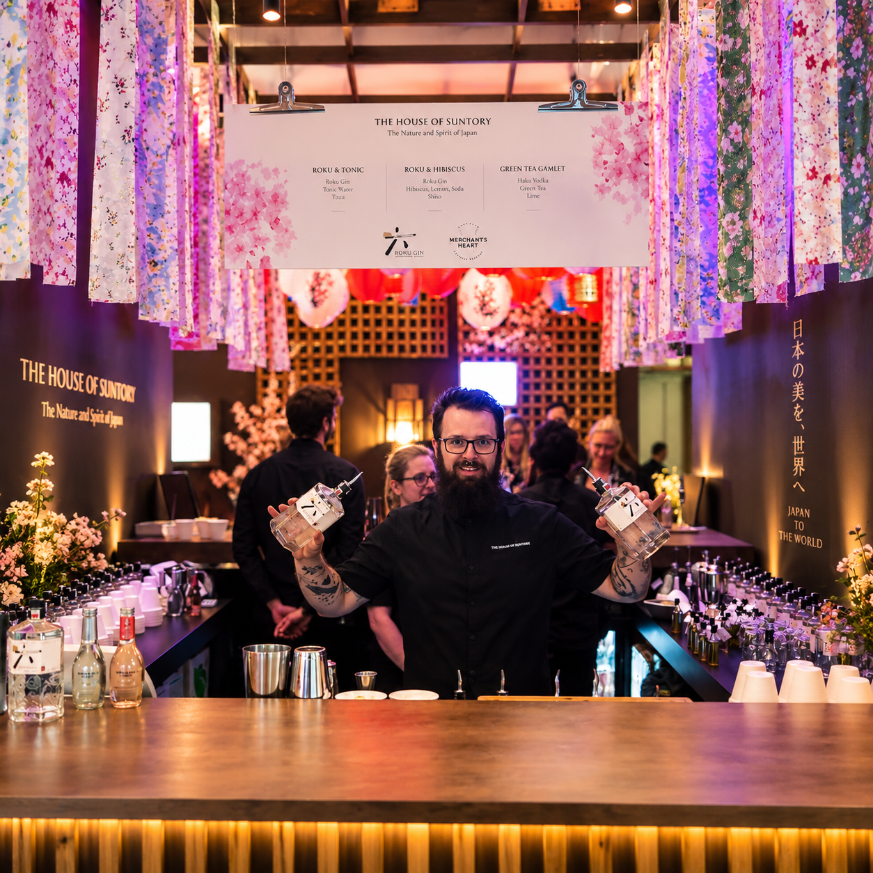 Bartender with bottles at The House of Suntory floral bar
