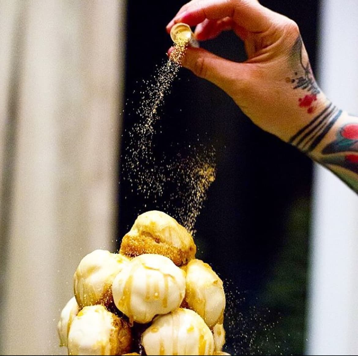 Gold dust falling over a profiterole tower