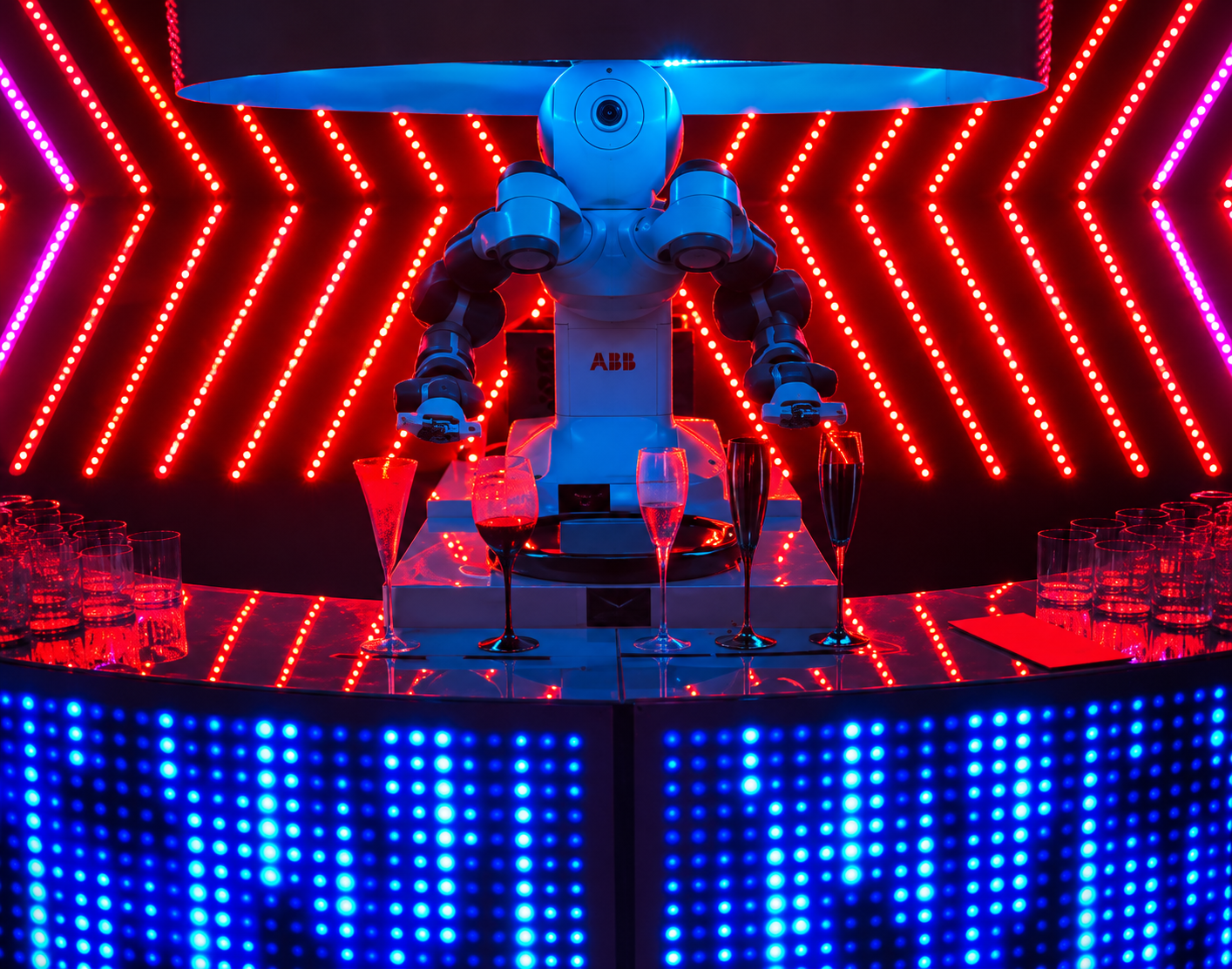Robot bartender at an illuminated event bar